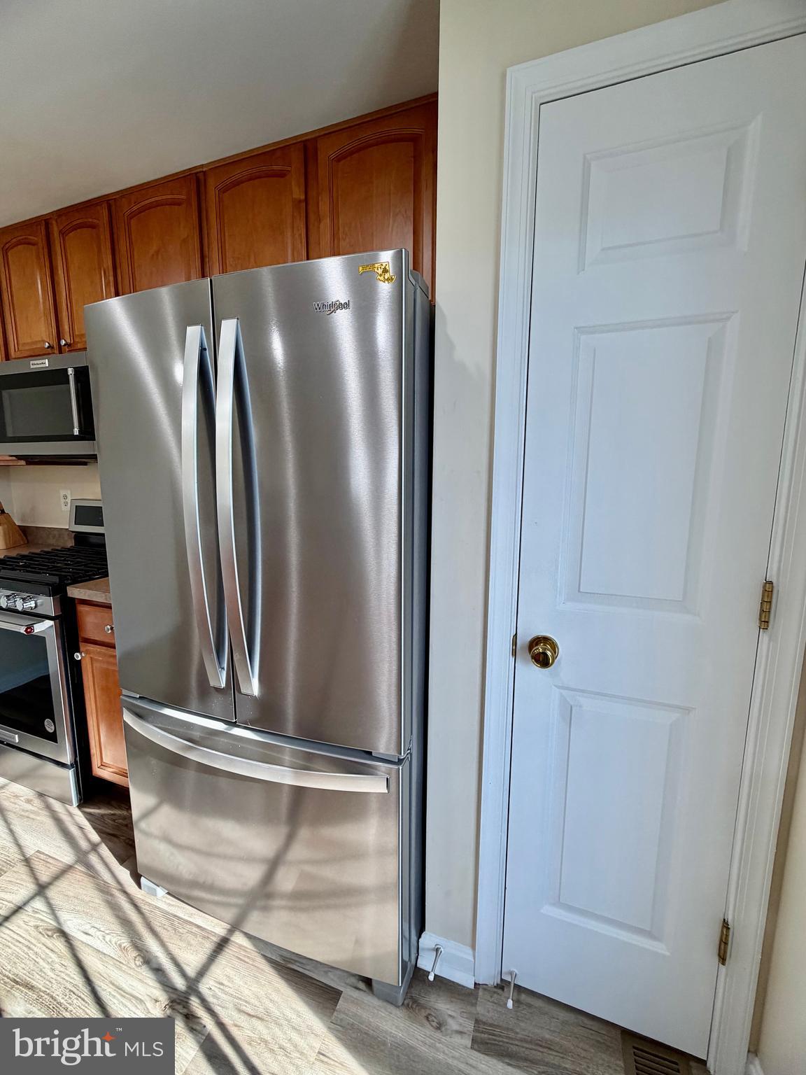 2013 Astilbe Way, Unit 2013 Odenton, MD 21113 - Photo 9 of 61 a view of a refrigerator in kitchen and an empty room