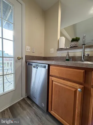 a kitchen with a sink appliances and cabinets