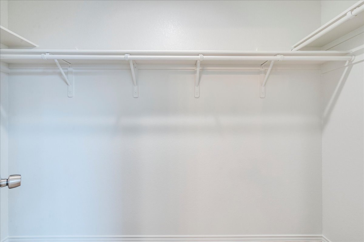 100 Easy Street Hutto, TX 78634 - Photo 17 of 36 Ready for organization, this generous closet features ample shelving and hanging space.