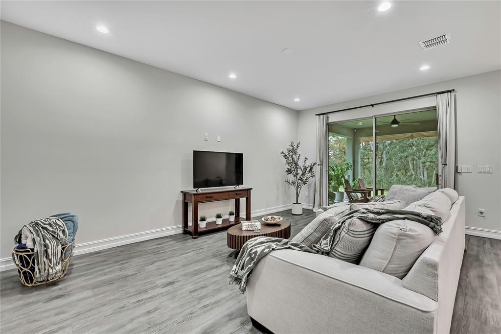 6098 North Peardale Terrace Beverly Hills, FL 34465 - Photo 13 of 59 a living room with furniture a flat screen tv and a large window