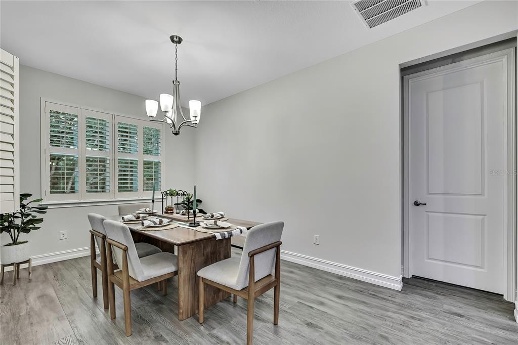 6098 North Peardale Terrace Beverly Hills, FL 34465 - Photo 16 of 59 a dining room with furniture wooden floor and a chandelier