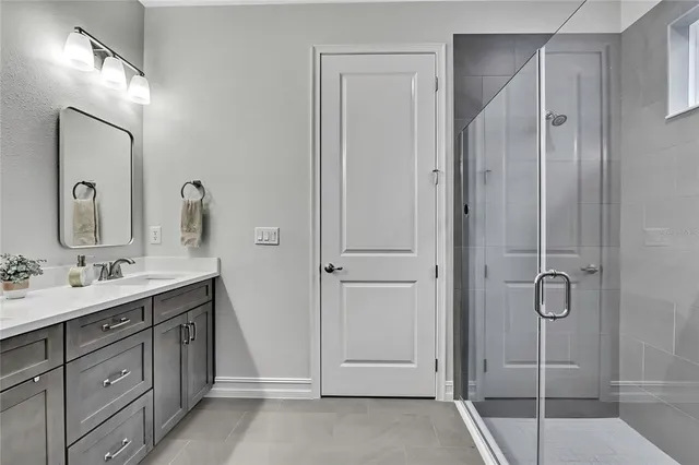 a bathroom with a double vanity sink and a mirror