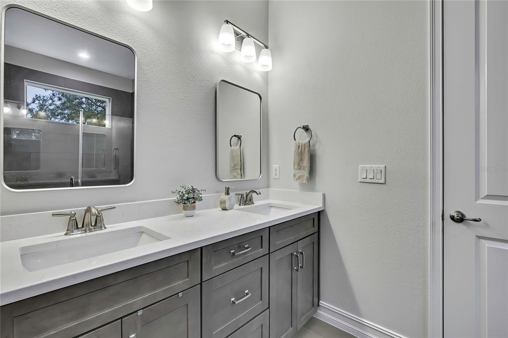 6098 North Peardale Terrace Beverly Hills, FL 34465 - Photo 23 of 59 a bathroom with a double vanity sink and a mirror