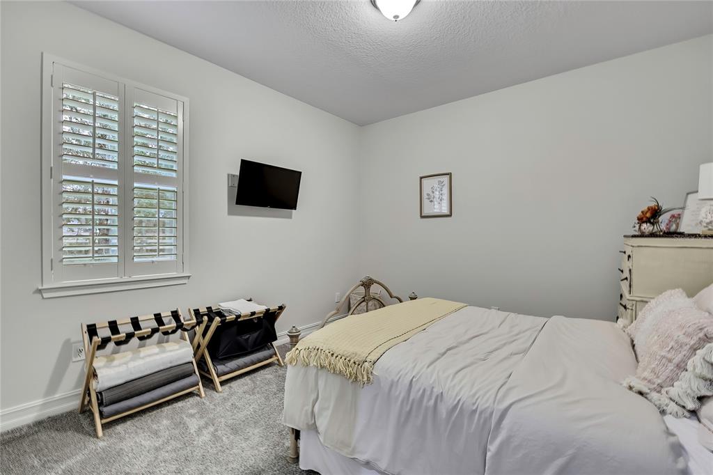 6098 North Peardale Terrace Beverly Hills, FL 34465 - Photo 29 of 59 a bedroom with a bed and a flat screen tv