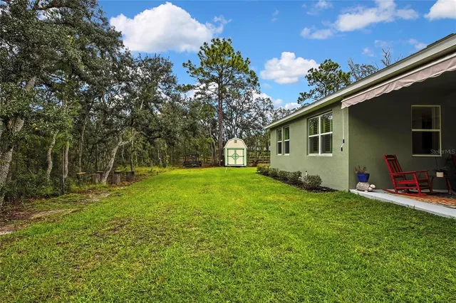 a view of backyard with a tub and trees