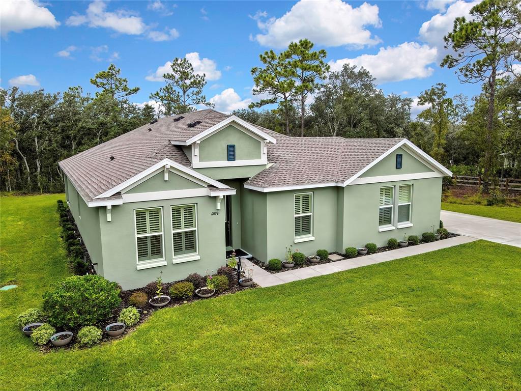 6098 North Peardale Terrace Beverly Hills, FL 34465 - Photo 48 of 59 a front view of a house with a yard