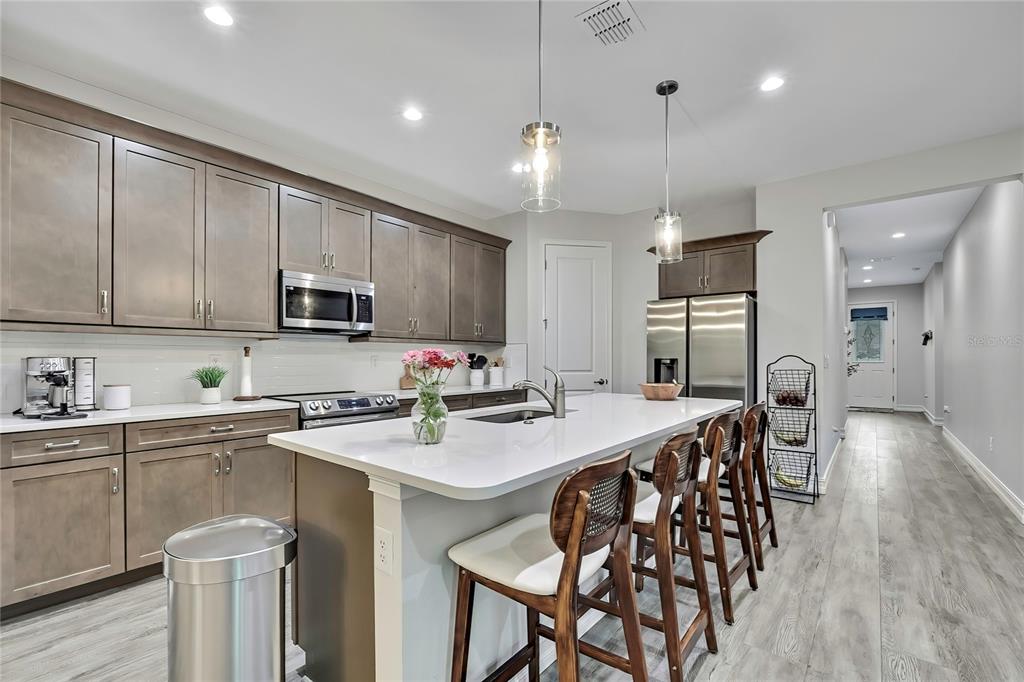 6098 North Peardale Terrace Beverly Hills, FL 34465 - Photo 7 of 59 a kitchen with stainless steel appliances a table chairs refrigerator and microwave