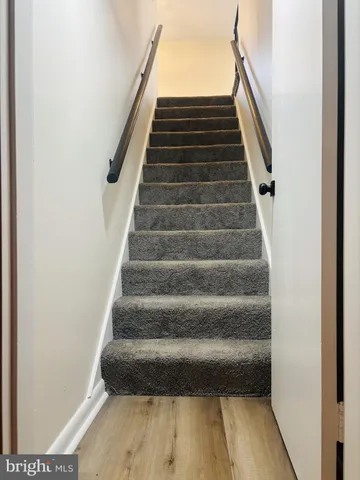 a view of a room that has wooden floor and a window