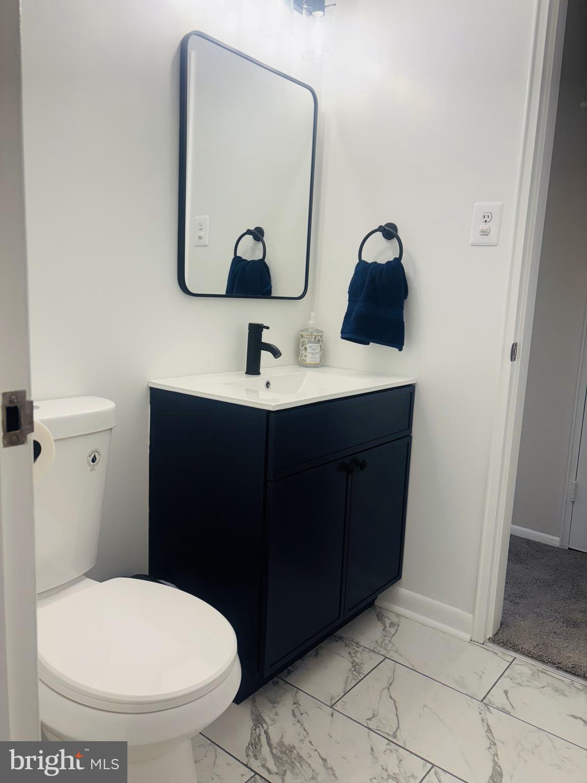 4714 Glenoak Road Hyattsville, MD 20784 - Photo 24 of 41 a bathroom with a toilet sink and mirror