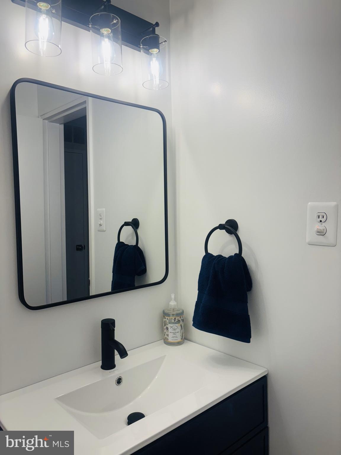 4714 Glenoak Road Hyattsville, MD 20784 - Photo 25 of 41 a bathroom with a sink and a mirror