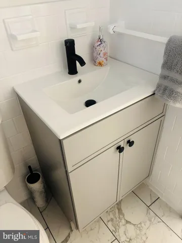 a bathroom with a sink vanity and toilet