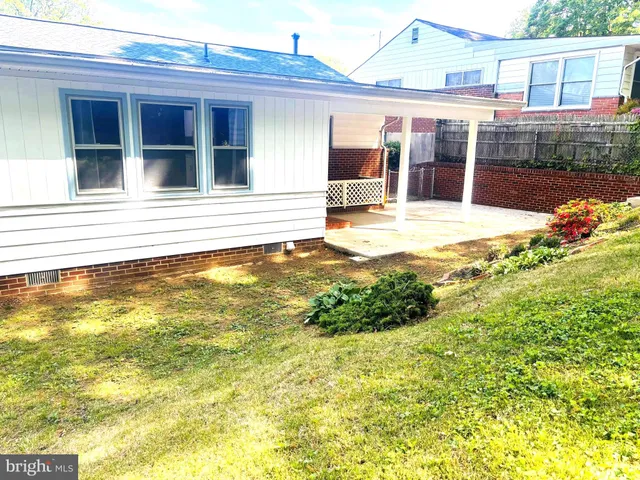a view of a house with a backyard porch and sitting area