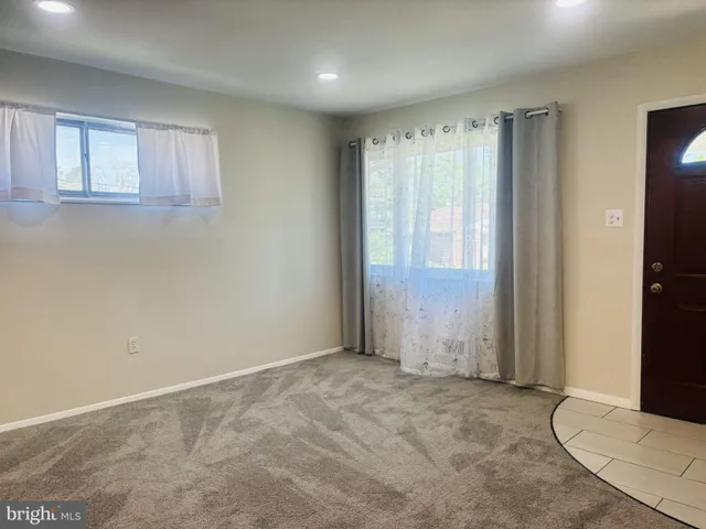 a large kitchen with a refrigerator a sink and cabinets