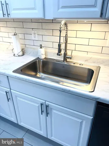 a kitchen with white cabinets