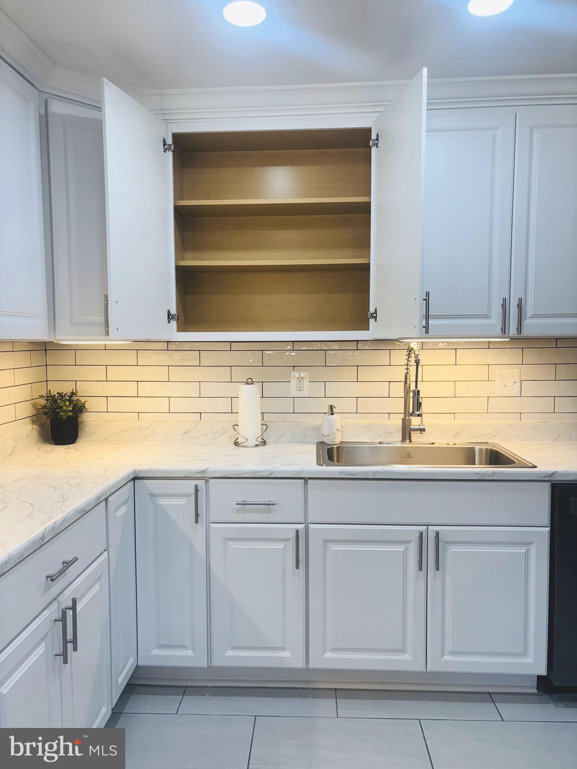 4714 Glenoak Road Hyattsville, MD 20784 - Photo 9 of 41 a kitchen with white cabinets
