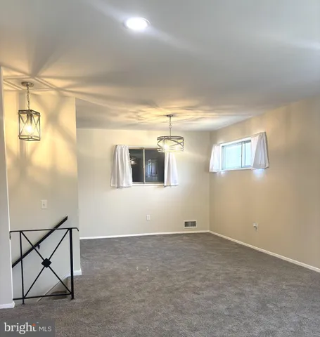 a view of a livingroom with furniture and natural light