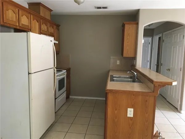 a white refrigerator freezer sitting inside of a kitchen