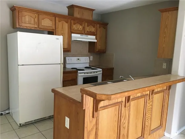 a white refrigerator freezer sitting inside of a kitchen