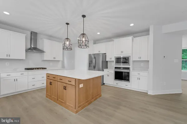 a large kitchen with stainless steel appliances kitchen island granite countertop a large counter top stainless steel appliances and cabinets