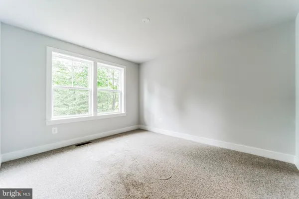 a backyard of a house with lots of green space and plants
