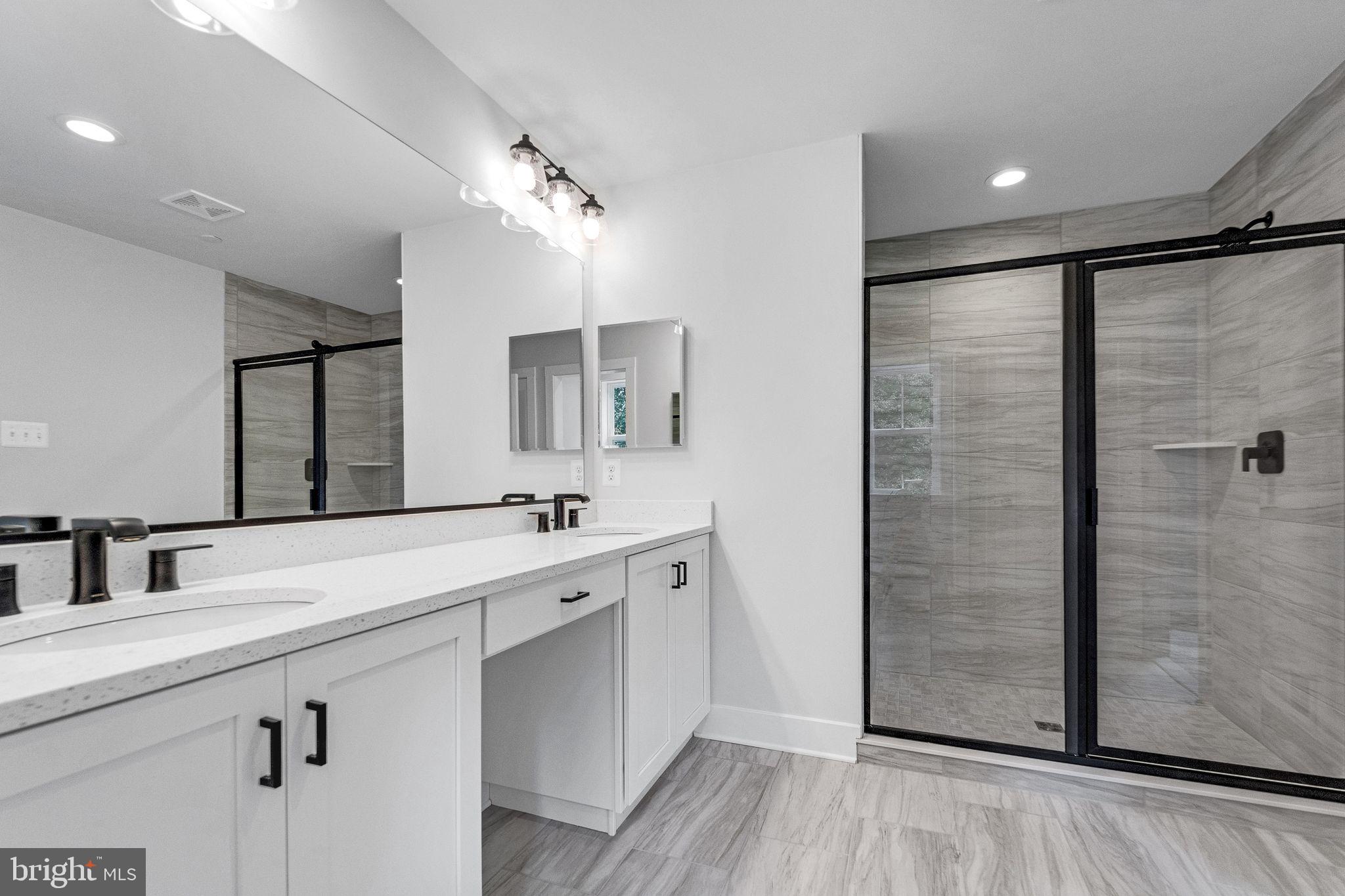 2229 A Ady Road Forest Hill, MD 21050 - Photo 45 of 75 a bathroom with a double vanity sink a mirror and shower