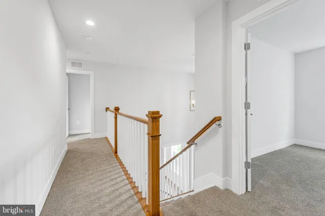 a view of a kitchen with wooden floor and a window