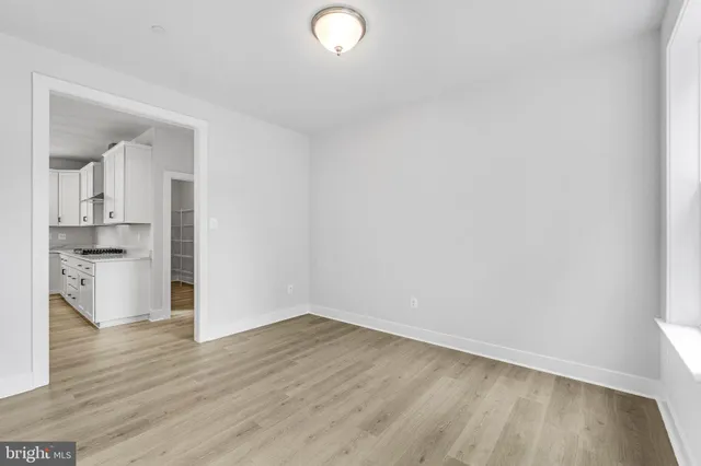 a kitchen with stainless steel appliances granite countertop a sink a stove and a wooden floors