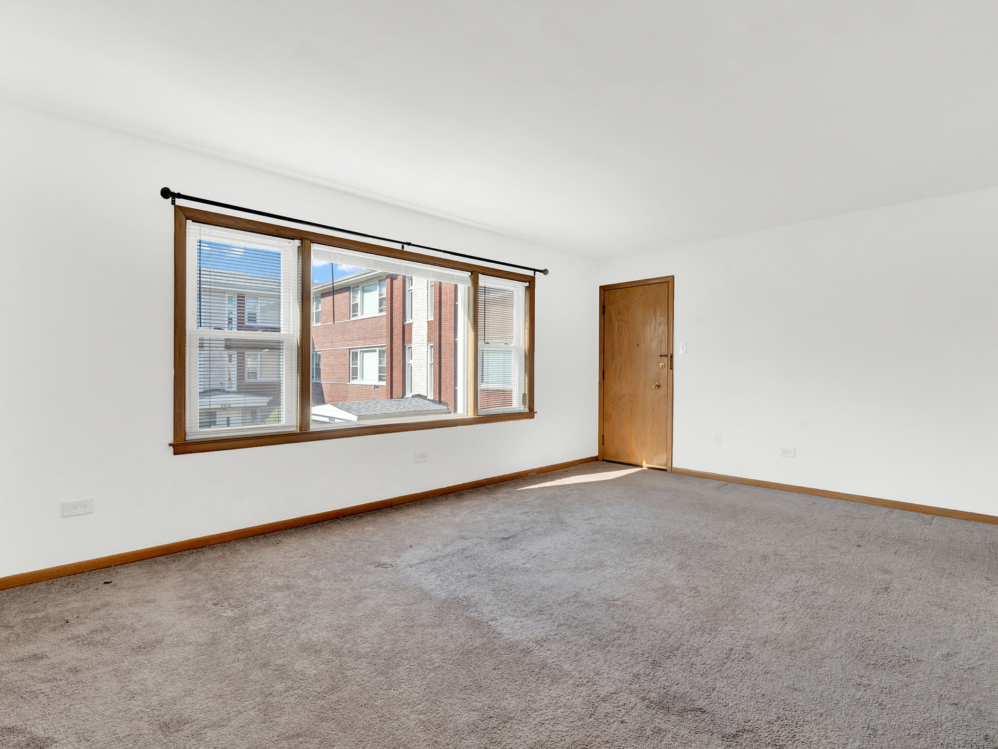 8000 South Pulaski Road, Unit 201 Chicago, IL 60652 - Photo 4 of 17 a view of an empty room with a window