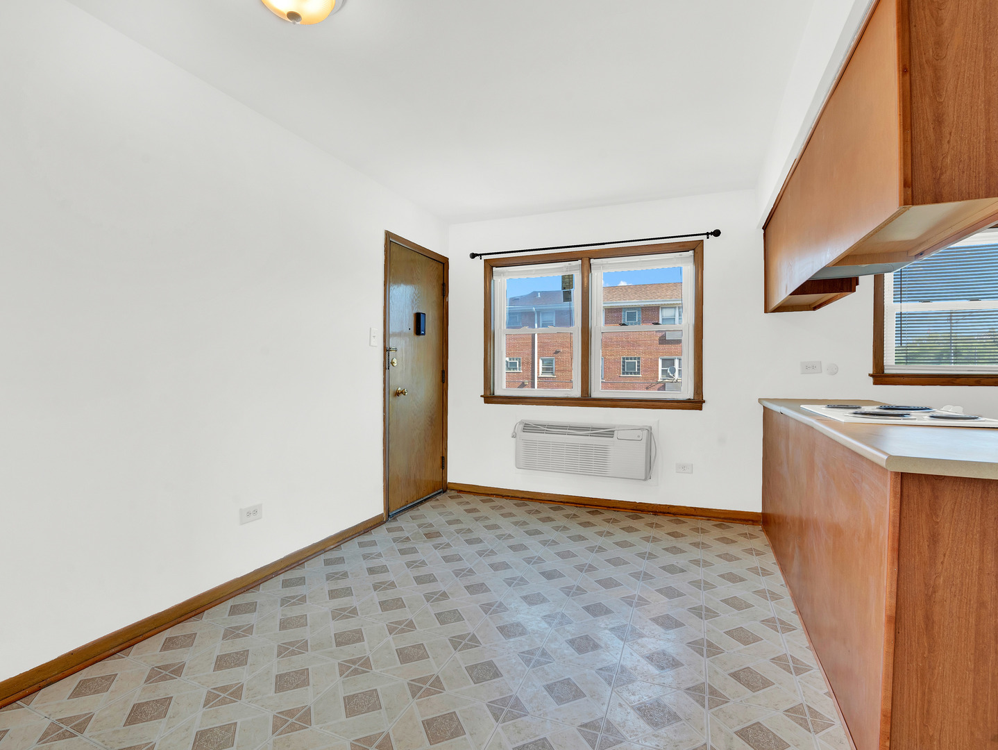 8000 South Pulaski Road, Unit 201 Chicago, IL 60652 - Photo 6 of 17 a view of a kitchen with wooden floor and a window