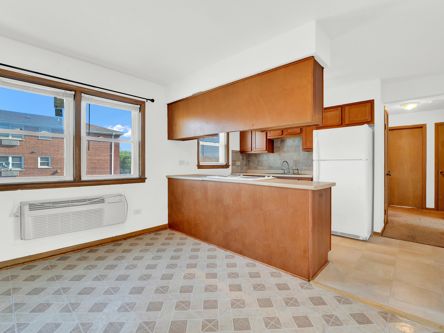 8000 South Pulaski Road, Unit 201 Chicago, IL 60652 - Photo 7 of 17 a room with a cabinets and a refrigerator