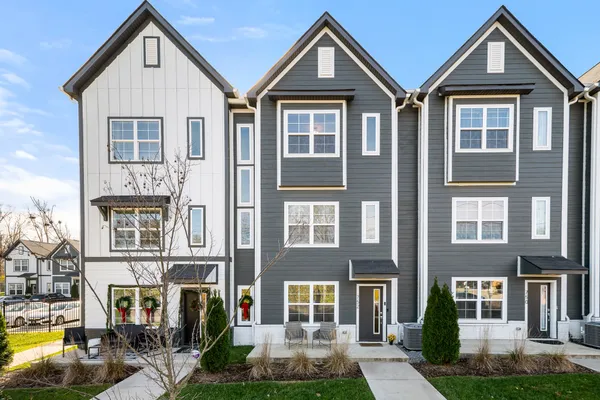 a front view of a residential apartment building with a yard