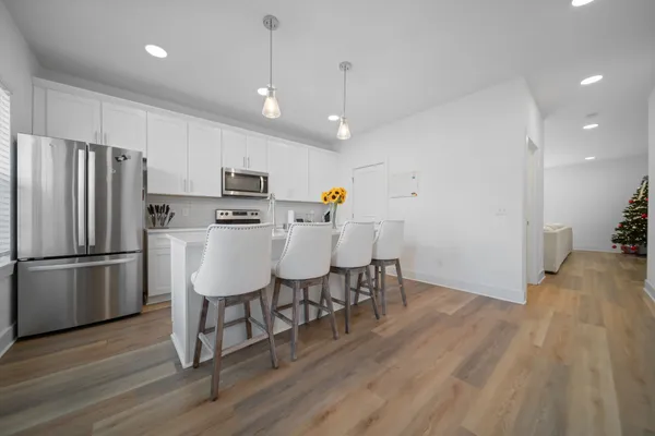 a kitchen with stainless steel appliances a refrigerator stove microwave and cabinets