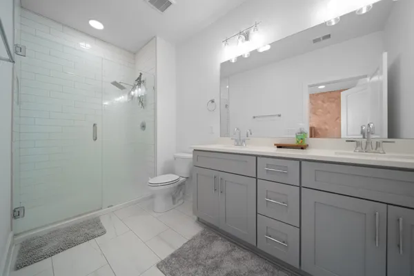 a bathroom with a double vanity sink and a mirror