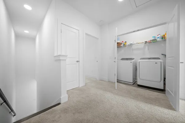 a view of a storage & utility room with refrigerator