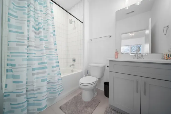 a bathroom with a granite countertop toilet a sink and a mirror