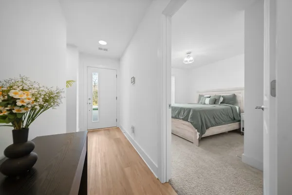 a bedroom with a bed and a potted plant
