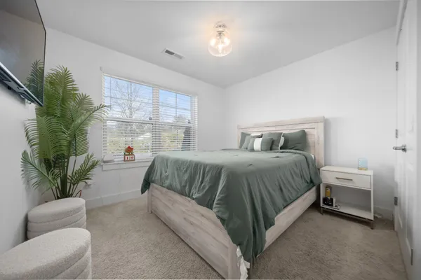 a spacious bedroom with a bed and a couch