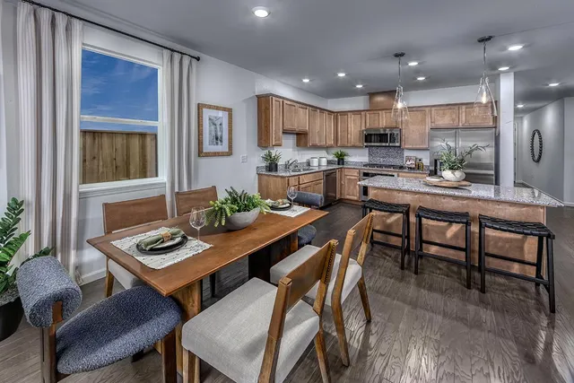 a kitchen with stainless steel appliances granite countertop a sink refrigerator and microwave