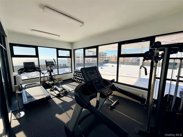 a room with gym equipment and a large window