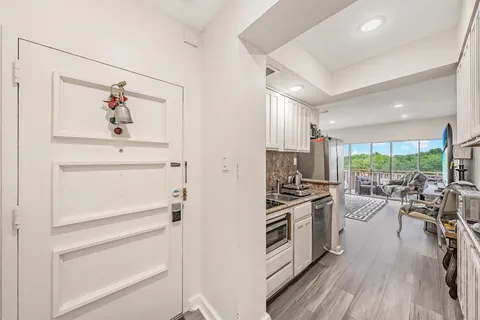 a kitchen with a refrigerator and a stove