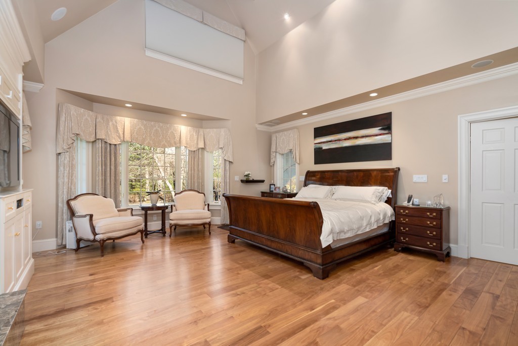 49 Possum Road Weston, MA 02493 - Photo 18 of 33 a bedroom with a bed couch and wooden floor