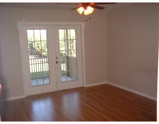 800 West Bayview Boulevard Portland, TX 78374 - Photo 4 of 10 a view of an empty room with wooden floor and a window