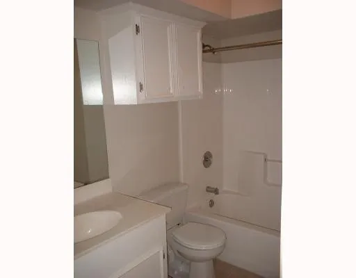 a bathroom with a toilet a sink and shower