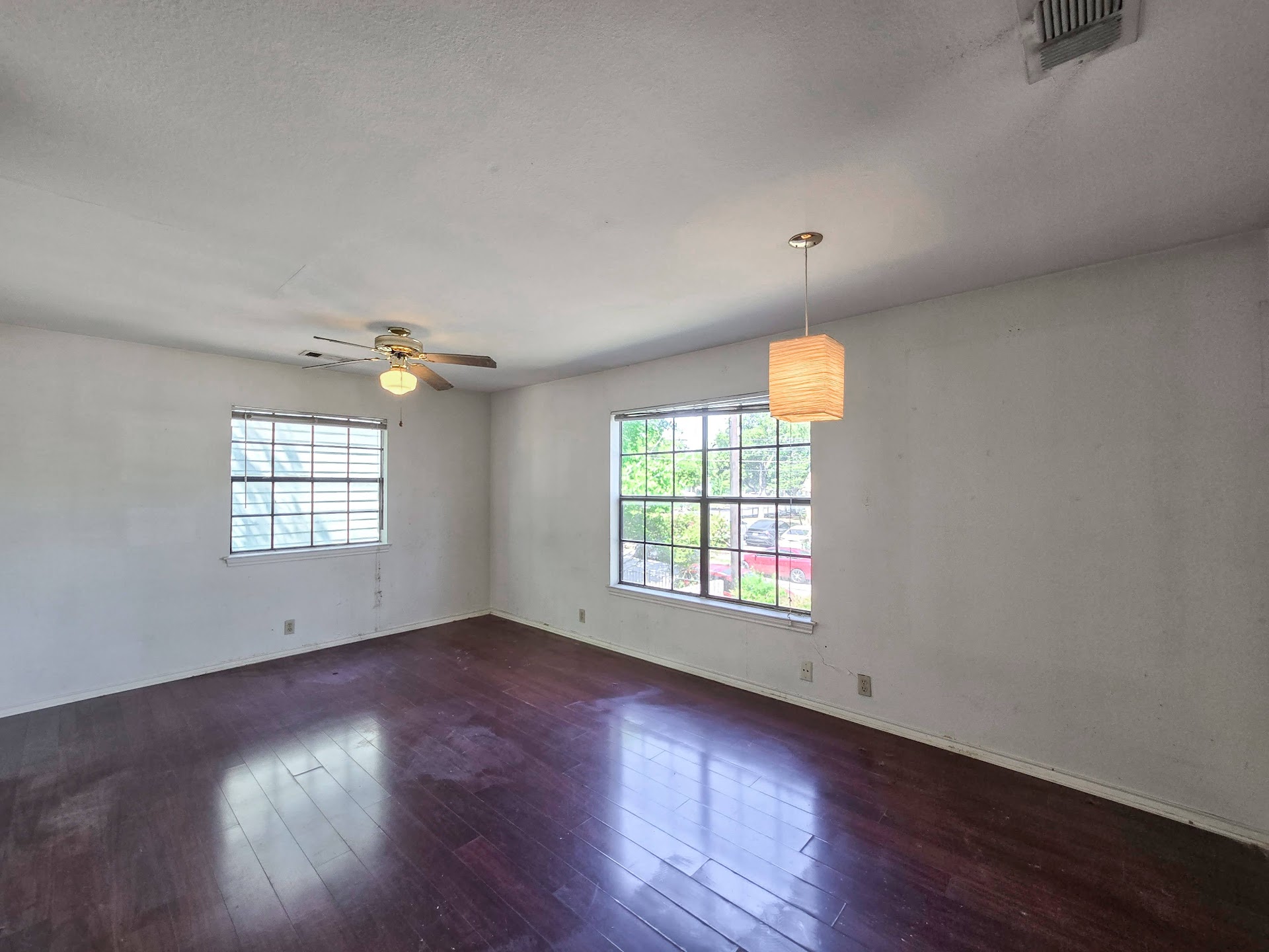 1903 East 20th Street, Unit 202 Austin, TX 78722 - Photo 3 of 8 Spare room with plenty of natural light, a ceiling fan, and wood finished floors