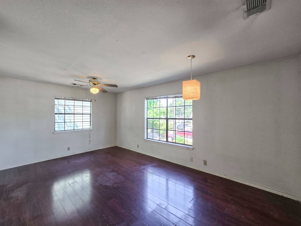 1903 East 20th Street, Unit 202 Austin, TX 78722 - Photo 3 of 8 an empty room with wooden floor and windows