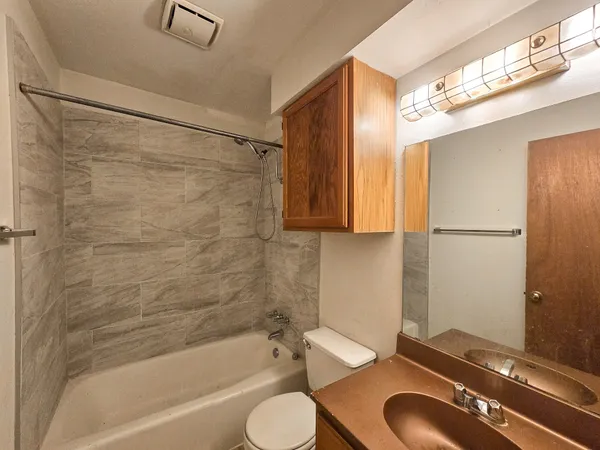 a bathroom with a sink toilet a mirror and shower
