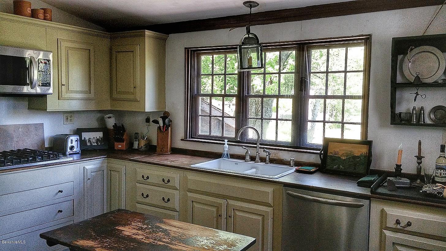 1600 Russell Road Montgomery, MA 01085 - Photo 13 of 36 a kitchen with a sink stove top oven and cabinets