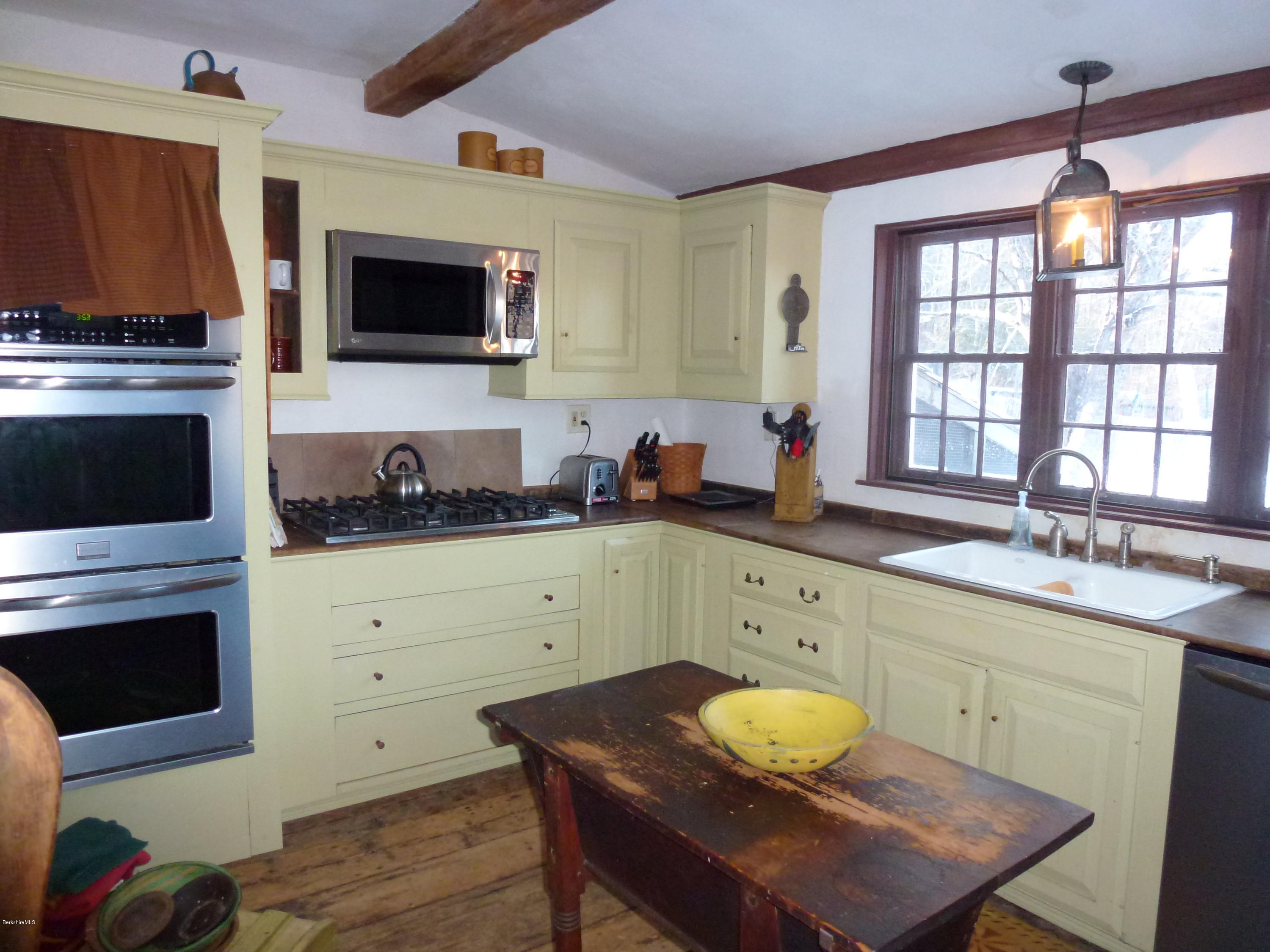 1600 Russell Road Montgomery, MA 01085 - Photo 14 of 36 a kitchen with stainless steel appliances a stove a sink and a microwave