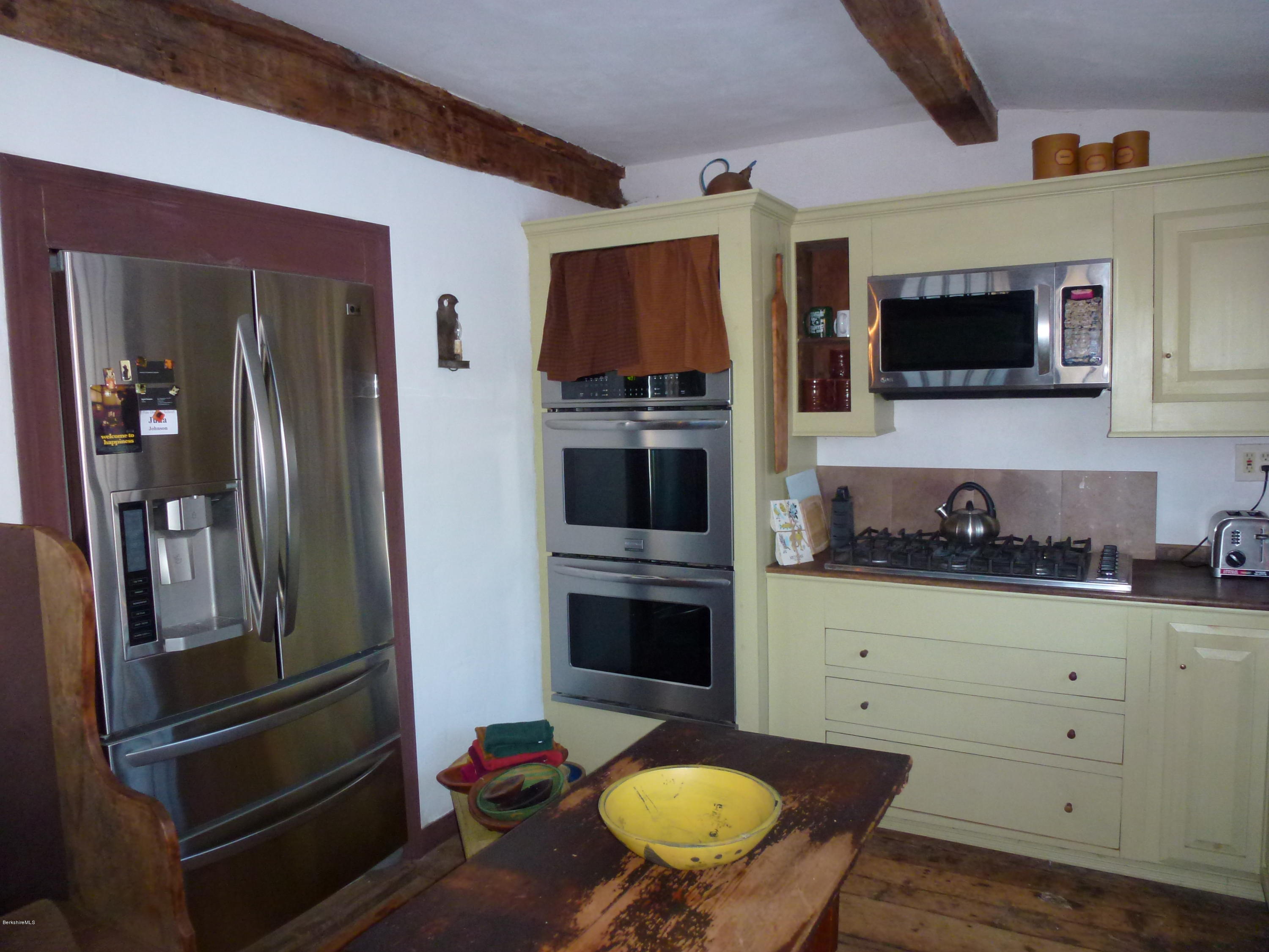 1600 Russell Road Montgomery, MA 01085 - Photo 15 of 36 a kitchen with stainless steel appliances kitchen island granite countertop a refrigerator and a stove top oven