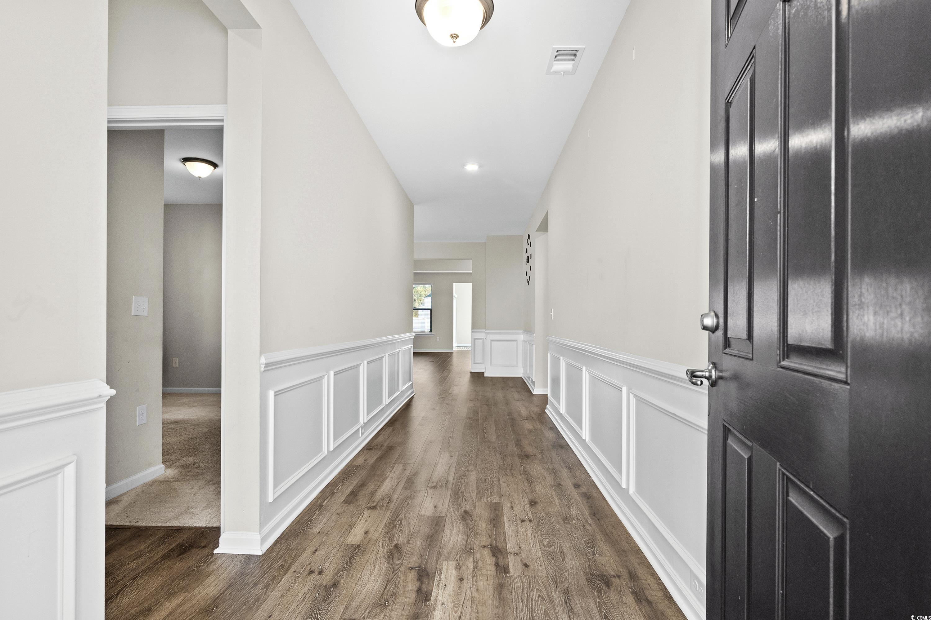 Corridor with dark hardwood / wood-style flooring